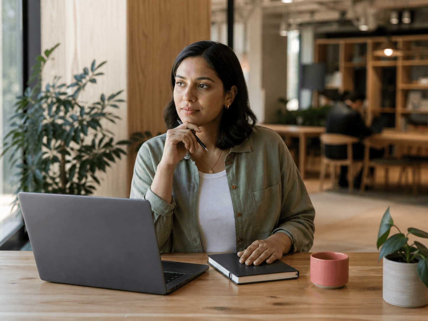 A professional considering career opportunities at a shared workspace